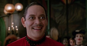 Movie still from “The Addams Family” (1991), directed by Barry Sonnenfeld – A person wearing a red shirt; Close Up shot, Low angle