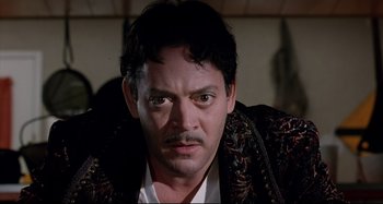 Movie still from “The Addams Family” (1991), directed by Barry Sonnenfeld – A person wearing a jacket; Close Up shot, Low angle