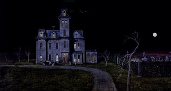 Movie still from “The Addams Family” (1991), directed by Barry Sonnenfeld – An image of an old house in the dark; Extreme Wide shot, Low angle