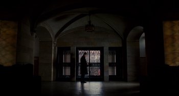 Movie still from “The Adjustment Bureau” (2011), directed by George Nolfi – A man standing in front of an arched doorway; Extreme Wide shot, Low angle