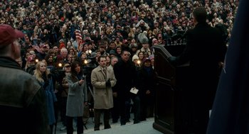 Movie still from “The Adjustment Bureau” (2011), directed by George Nolfi – A crowd of people standing in front of a podium; Extreme Wide shot, High angle