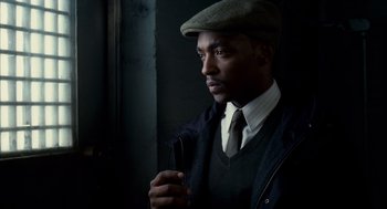 Movie still from “The Adjustment Bureau” (2011), directed by George Nolfi – A man wearing a hat and holding a cane; Close Up shot, Low angle