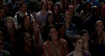 Movie still from “The Adjustment Bureau” (2011), directed by George Nolfi – A group of people sitting in front of a microphone; Medium shot, High angle