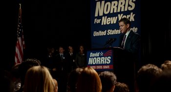 Movie still from “The Adjustment Bureau” (2011), directed by George Nolfi – A man standing in front of a crowd of onlookers at a political event; Medium shot, High angle