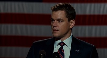 Movie still from “The Adjustment Bureau” (2011), directed by George Nolfi – A person wearing a suit and tie; Close Up shot, Low angle