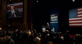 Movie still from “The Adjustment Bureau” (2011), directed by George Nolfi – A man is speaking at a political event; Extreme Wide shot, High angle