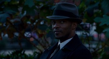 Movie still from “The Adjustment Bureau” (2011), directed by George Nolfi – A man wearing a hat and a coat; Close Up shot, Over the shoulder angle