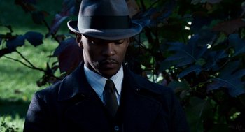 Movie still from “The Adjustment Bureau” (2011), directed by George Nolfi – A man wearing a hat and a suit; Close Up shot, High angle