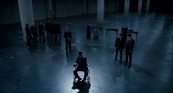 Movie still from “The Adjustment Bureau” (2011), directed by George Nolfi – A group of men in suits and ties sitting in a room; Extreme Wide shot, High angle
