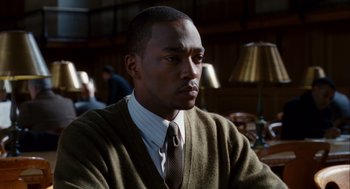 Movie still from “The Adjustment Bureau” (2011), directed by George Nolfi – A man wearing a sweater and a neck tie; Close Up shot, Over the shoulder angle