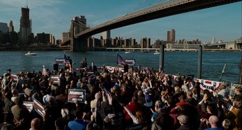 Movie still from “The Adjustment Bureau” (2011), directed by George Nolfi – A crowd of people on a boat in front of a bridge; Extreme Wide shot, High angle