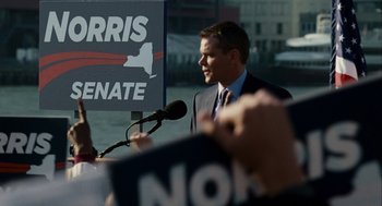 Movie still from “The Adjustment Bureau” (2011), directed by George Nolfi – A man in a business suit is speaking to a crowd; Medium shot, High angle