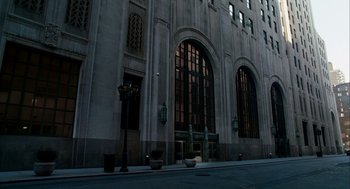 Movie still from “The Adjustment Bureau” (2011), directed by George Nolfi – A large building with large windows on the side of the building; Extreme Wide shot, Low angle
