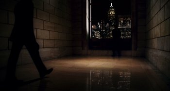 Movie still from “The Adjustment Bureau” (2011), directed by George Nolfi – A person standing in front of a window at night; Extreme Wide shot, High angle