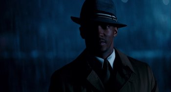 Movie still from “The Adjustment Bureau” (2011), directed by George Nolfi – A man wearing a suit and a hat in the dark; Close Up shot, Low angle