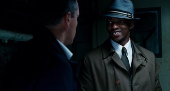 Movie still from “The Adjustment Bureau” (2011), directed by George Nolfi – A man in a suit and a hat talking to another man in a suit and a hat; Close Up shot, Over the shoulder angle