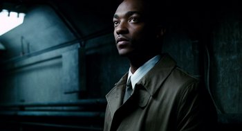 Movie still from “The Adjustment Bureau” (2011), directed by George Nolfi – A man wearing a trench coat and tie; Close Up shot, Low angle