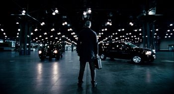 Movie still from “The Adjustment Bureau” (2011), directed by George Nolfi – A man standing in the middle of a parking lot; Wide shot, Low angle