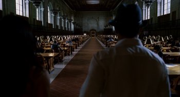 Movie still from “The Adjustment Bureau” (2011), directed by George Nolfi – People sitting at tables in a large room; Extreme Wide shot, High angle