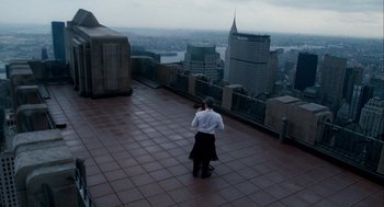 Movie still from “The Adjustment Bureau” (2011), directed by George Nolfi – A man standing on a rooftop looking out over a city; Extreme Wide shot, High angle