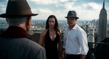 Movie still from “The Adjustment Bureau” (2011), directed by George Nolfi – Two men and a woman standing in front of a city; Medium shot, Over the shoulder angle