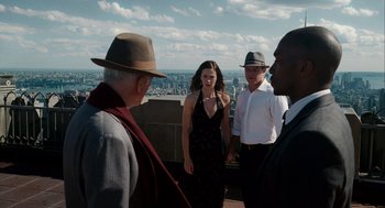 Movie still from “The Adjustment Bureau” (2011), directed by George Nolfi – A group of people standing on top of a building; Medium shot, Over the shoulder angle