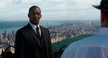 Movie still from “The Adjustment Bureau” (2011), directed by George Nolfi – A man in a suit and tie standing in front of a city; Medium shot, Over the shoulder angle