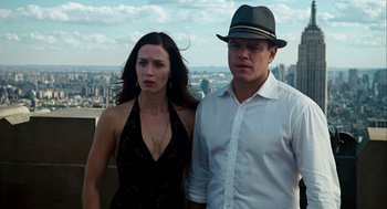 Movie still from “The Adjustment Bureau” (2011), directed by George Nolfi – A man and a woman standing next to each other in front of a city; Close Up shot, Low angle