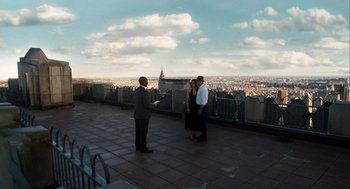 Movie still from “The Adjustment Bureau” (2011), directed by George Nolfi – A man and a woman standing next to each other on a balcony; Extreme Wide shot, High angle