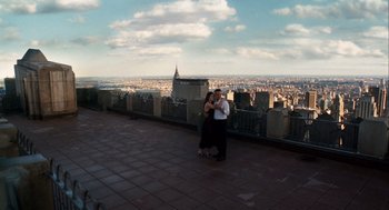 Movie still from “The Adjustment Bureau” (2011), directed by George Nolfi – Two people standing on a ledge overlooking a city; Extreme Wide shot, High angle