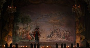 Movie still from “The Adventures of Baron Munchausen” (1988), directed by Terry Gilliam – A man in a pirate costume standing in front of a painting; Extreme Wide shot, High angle