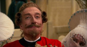 Movie still from “The Adventures of Baron Munchausen” (1988), directed by Terry Gilliam – A person wearing a costume; Close Up shot, Low angle