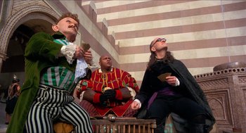 Movie still from “The Adventures of Baron Munchausen” (1988), directed by Terry Gilliam – A group of people dressed up in costumes; Medium shot, Low angle