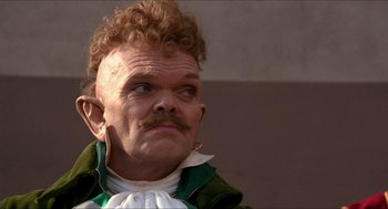 Movie still from “The Adventures of Baron Munchausen” (1988), directed by Terry Gilliam – A person wearing a costume; Close Up shot, Low angle