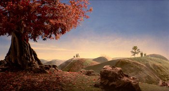 Movie still from “The Adventures of Baron Munchausen” (1988), directed by Terry Gilliam – Three people standing on a hill in the distance; Extreme Wide shot, High angle