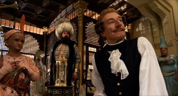 Movie still from “The Adventures of Baron Munchausen” (1988), directed by Terry Gilliam – A man in a suit and a man in a wig; Medium shot, Over the shoulder angle