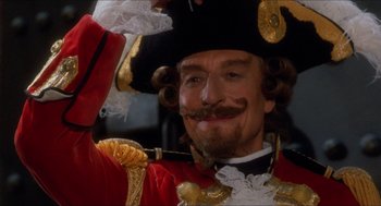 Movie still from “The Adventures of Baron Munchausen” (1988), directed by Terry Gilliam – A person wearing a hat with a mustache; Close Up shot, Low angle