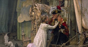 Movie still from “The Adventures of Baron Munchausen” (1988), directed by Terry Gilliam – A painting of a young girl kissing a man; Wide shot, Over the shoulder angle