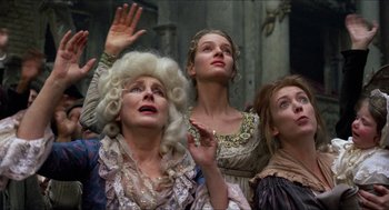 Movie still from “The Adventures of Baron Munchausen” (1988), directed by Terry Gilliam – A group of people that are standing in a room; Medium shot, Low angle
