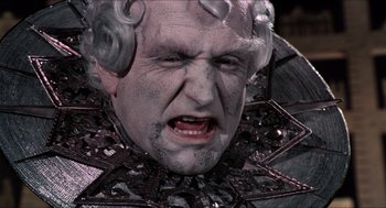 Movie still from “The Adventures of Baron Munchausen” (1988), directed by Terry Gilliam – An old man with a very large face and a very weird look on his face; Close Up shot, Low angle
