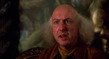 Movie still from “The Adventures of Baron Munchausen” (1988), directed by Terry Gilliam – An old man with a bald head and a long hair; Close Up shot, Over the shoulder angle