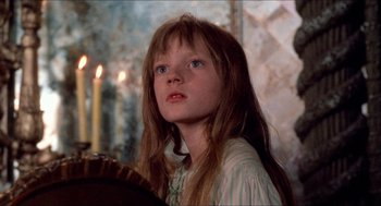 Movie still from “The Adventures of Baron Munchausen” (1988), directed by Terry Gilliam – A young girl with long hair looking up at the sky; Close Up shot, Over the shoulder angle