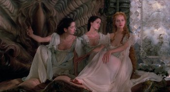 Movie still from “The Adventures of Baron Munchausen” (1988), directed by Terry Gilliam – A group of three women sitting next to each other; Wide shot, High angle