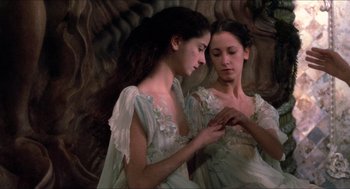Movie still from “The Adventures of Baron Munchausen” (1988), directed by Terry Gilliam – Two young women dressed in old - fashioned clothing; Close Up shot, High angle