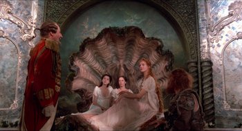 Movie still from “The Adventures of Baron Munchausen” (1988), directed by Terry Gilliam – A group of women sitting on top of a giant seashell; Wide shot, Low angle