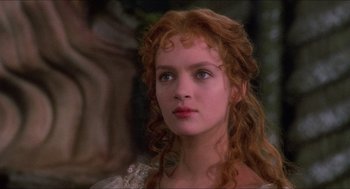 Movie still from “The Adventures of Baron Munchausen” (1988), directed by Terry Gilliam – A person with long red curly hair; Close Up shot, Over the shoulder angle