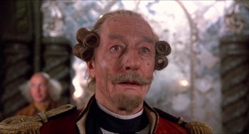 Movie still from “The Adventures of Baron Munchausen” (1988), directed by Terry Gilliam – An old man with a beard and a mustache; Close Up shot, Low angle