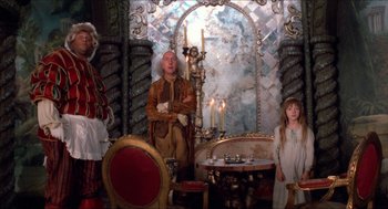Movie still from “The Adventures of Baron Munchausen” (1988), directed by Terry Gilliam – A group of people standing in a room with candles; Wide shot, High angle