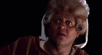 Movie still from “The Adventures of Baron Munchausen” (1988), directed by Terry Gilliam – A person wearing a wig; Close Up shot, Low angle