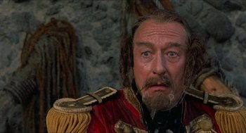 Movie still from “The Adventures of Baron Munchausen” (1988), directed by Terry Gilliam – A man with a beard and a mustache wearing a red and gold uniform; Close Up shot, Low angle